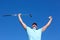 Hole in one. Low-angle shot of a mature male golfer with his arms raised in celebration.