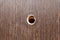 hole for a peephole on the brown front door.