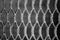 Holey metallic lattice texture. background. black and white photography