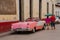 Holguin, Cuba: retro old pink car parked on a street in the city center.