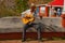 HOLGUIN, CUBA: Senior man with guitar wearing a traditional panama straw hat busking in a street