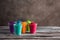 Holi festival.Colorful holi powders in plastic cups on a wooden old table. Selective focus