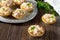 Holiday appetizer: tartlets with crab sticks, cheese and pineapple on a wooden table