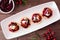 Holiday appetizers with cranberries, goat cheese and pecans on a serving plate, top view table scene on wood