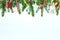 Holiday background with christmas tree branches, various decorations and glowing light garlands