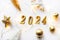 Holiday background Happy New Year 2024. Figures 2024 on a white background with Christmas decorations, balls and a