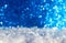 Holiday background with  snow crystals and shiny silver blue sparks and circles