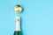 Holiday Bottle of champagne and Christmas toys over blue background. Christmas and New Year celebration. Copy space. Bottle with