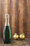 Holiday Bottle of champagne and Christmas toys over wooden background. Christmas and New Year celebration. Bottle with Sparkling