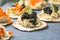 Holiday canapes with red and black caviar, on crackers festive silver Christmas decoration, copy space, selected focus, narrow
