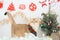 holiday and cat concept with british cat wear silk scarf and play with pine and christmas tree decorate background