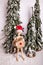 Holiday Christmas wintery scene with wooden jointed doll standing holding gift wearing Santa Claus hat