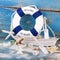 Holiday concept - maritime decoration - Toy boat with a blue life bouy