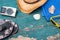 Holiday Concept: Vintage wood table with holiday accessories: Straw hat, sunglasses, flip flops, shells, vintage camera and bath