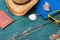 Holiday Concept: Vintage wood table with holiday accessories: Straw hat, sunglasses, shells, vintage camera and bath towel