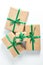 Holiday concert. gifts wrapped in craft paper and tied with a green satin ribbon on a white background. space for text, flat lay