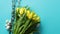 Holiday contept decoration with easter eggs and yellow tulips over blue