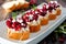 Holiday crostini appetizers with cranberries, pomegranates and feta, close up table scene