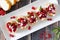 Holiday crostini appetizers with cranberries, pomegranates and feta, top view table scene