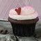 Holiday Cupcake with Heart On Wood Background