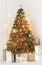 Holiday decorated room with Christmas tree and decoration, background with blurred, sparking, glowing light.