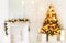 Holiday decorated room with Christmas tree and decoration, background with blurred, sparking, glowing light.