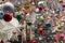 Holiday decorations in silver, red, gold, blue, green, and white seen with twinkling lights of window