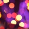 Holiday defocused glowing backdrop with yellow, red, purple lights