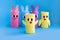 Holiday easy DIY craft idea for kids. Toilet paper roll tube toy\\\'s rabbit and chick on blue background