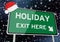 Holiday exit here on signpost or billboard against starry sky at christmas or xmas night. Concept Image