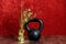 Holiday fitness, black kettlebell, gold decoration with spires and stars against a red background