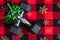 Holiday fitness, pair of 15-pound dumbbells on a holiday background of red and black with gold snowflakes, green ribbon