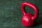 Holiday fitness, red kettle bell on a multi-shade green background with white sparkles