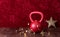 Holiday fitness, red kettlebell with gold star twinkle lights, big gold star, against a red background