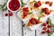 Holiday flatbread appetizers with cranberries and brie, above on a bright background