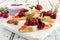 Holiday flatbread appetizers with cranberries and brie, close up on a bright background