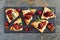 Holiday flatbread appetizers with cranberries and brie, top view on slate platter