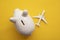 Holiday flight fare saving concept. Piggy bank with a toy plane. Vacation budget planning