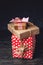 Holiday gift boxes Packed in crafting paper and red polka dots on dark wooden background. Concept of cards with gifts