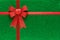 Holiday green background with red ribbon