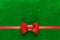 Holiday green background with red ribbon