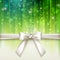 Holiday green background with a white bow