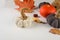 Holiday greeting card with Knitted decorative pumpkins, gifts, fall leaves, chestnuts