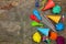 Holiday hats, whistles, balloons on old wooden background.