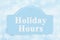 Holiday Hours message sign with a blue snowflakes