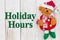 Holiday Hours sign with cute Santa bear