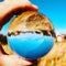 Holiday houses reflecting in mirror ball