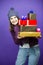 Holiday Ideas. Winsome Laughing Caucasian Adult Female in Seasonal Warm Clothing Posing with Stack of Wrapped Present Gift Boxes