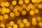 Holiday illumination of sparkling brown and yellow bokeh background