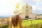 Holiday in Italy. Back view of beautiful girl visiting the Basilica of Saint Francis of Assisi on sunny day